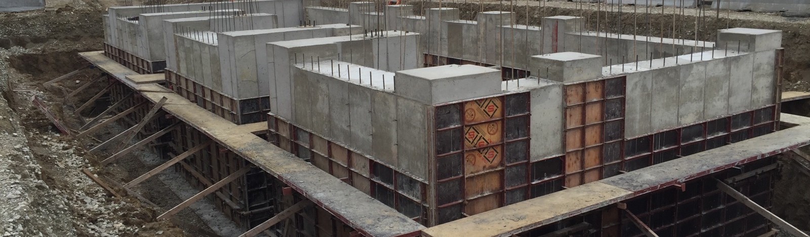 Concrete foundation walls and rebar under construction for a pre-engineered metal building