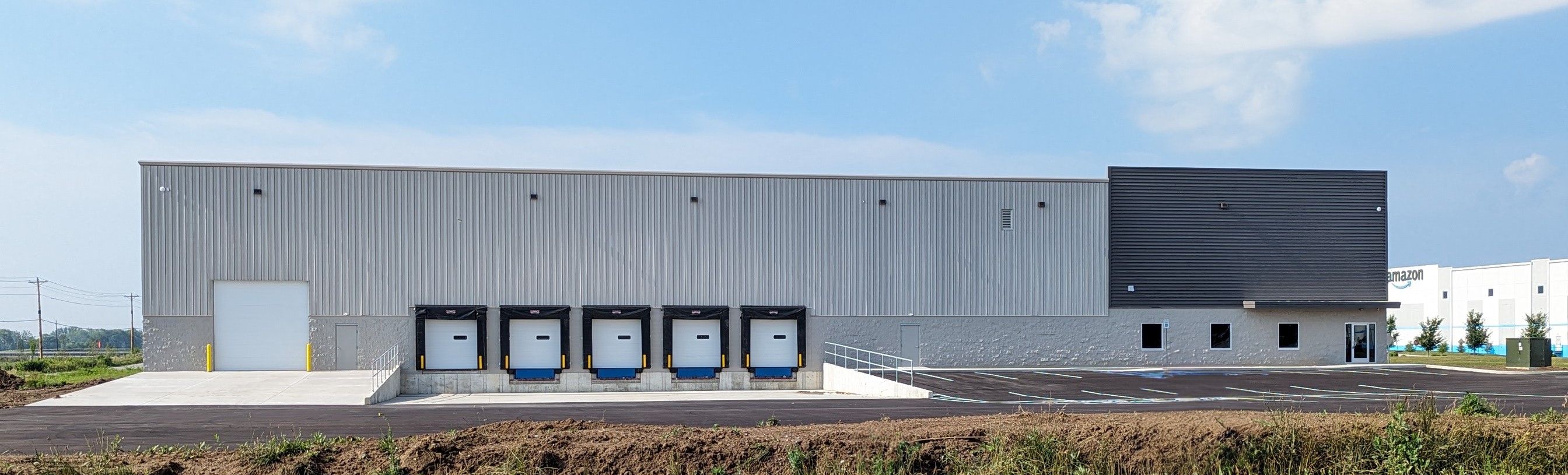 Pre-engineered metal warehouse with five loading dock doors by Systems Builders, Indianapolis