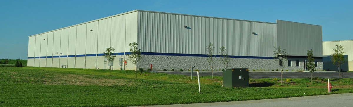 Tan pre-engineered metal building with blue accent band by Systems Builders, Indianapolis